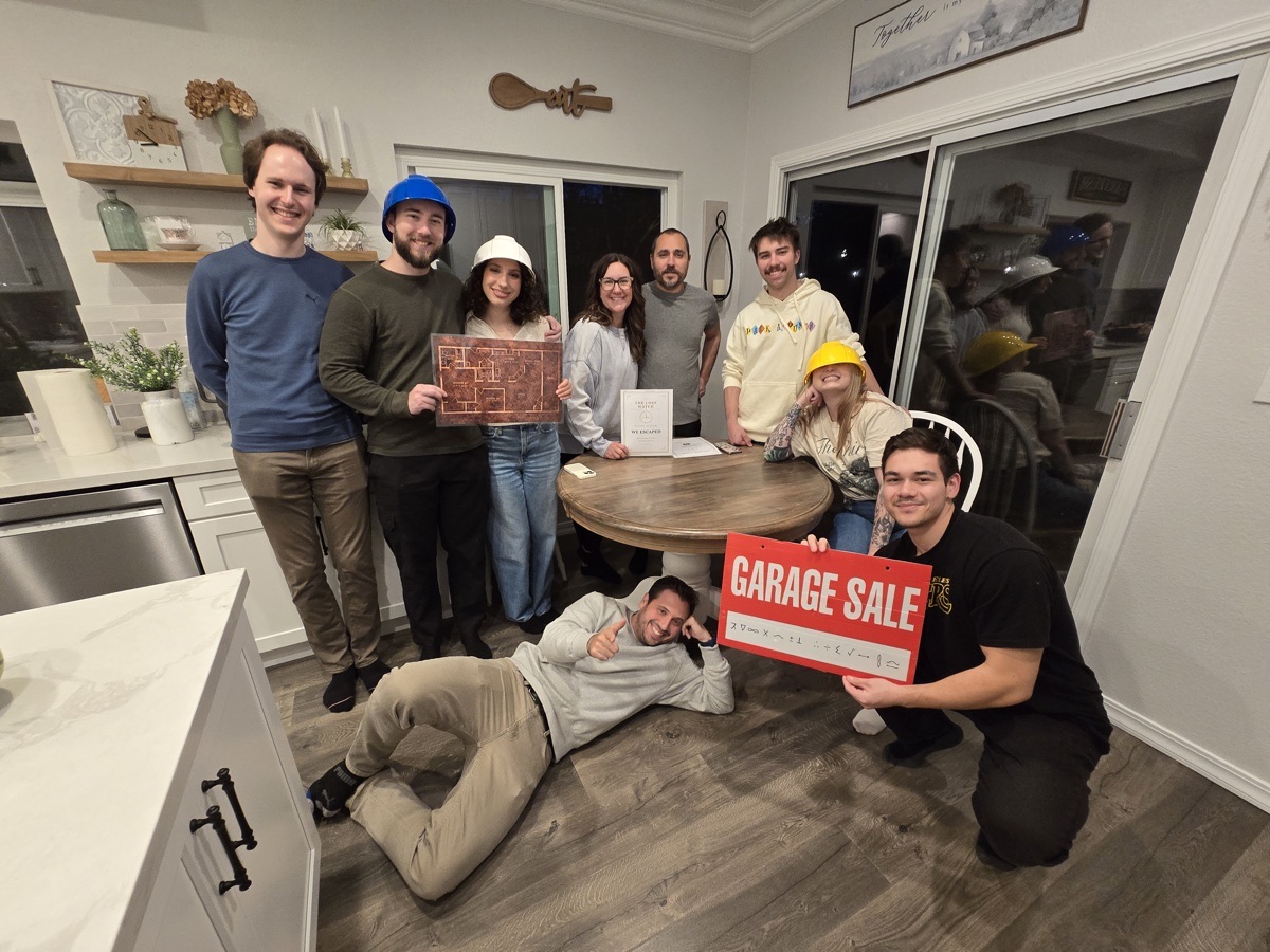 A group celebrating after escaping, in a home kitchen we set up